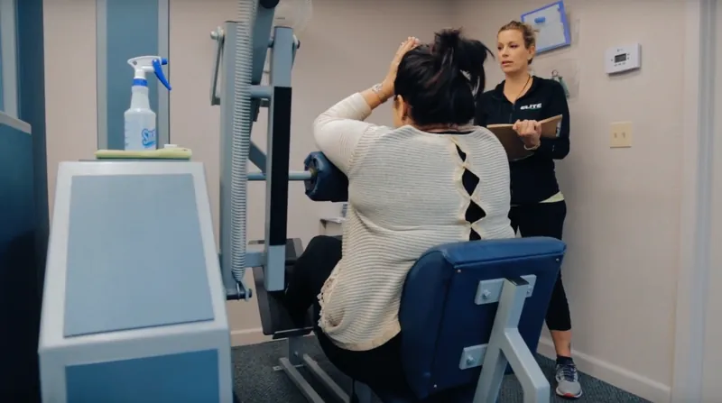 Certified trainer coaching a client through a strength exercise